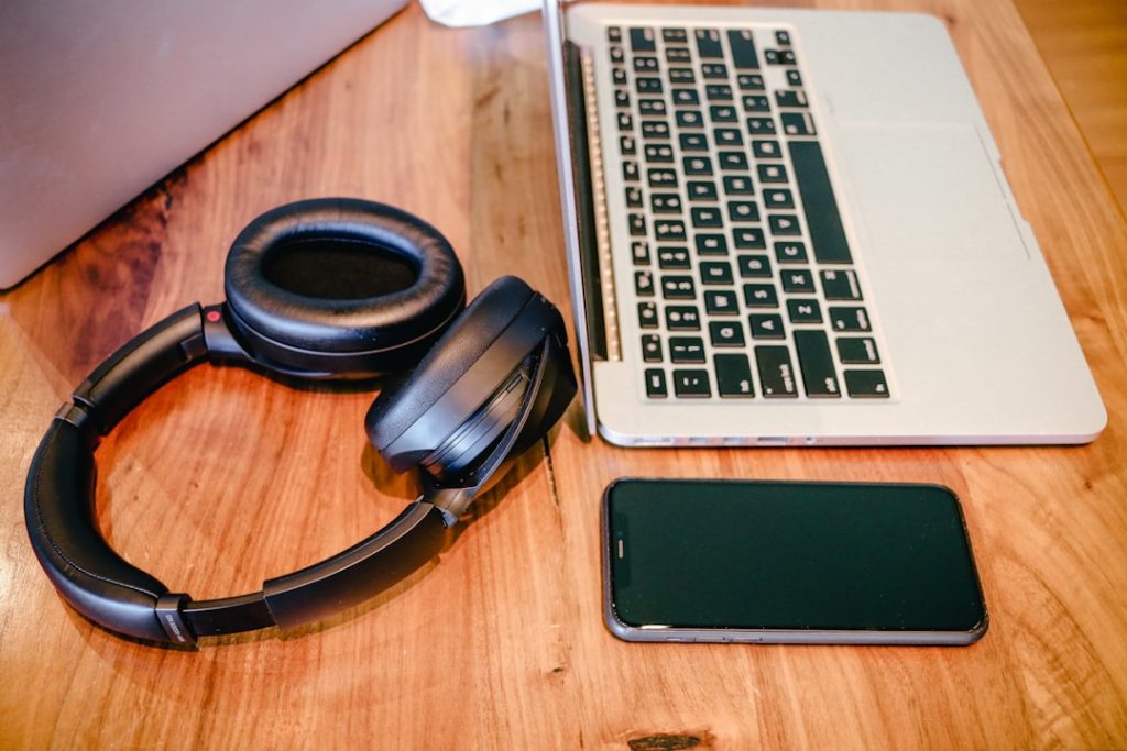 a-laptop-and-headphones-on-a-wooden-table-ebffugiguws iPhone 11 Pro, headphones, and two laptops on a small table for work